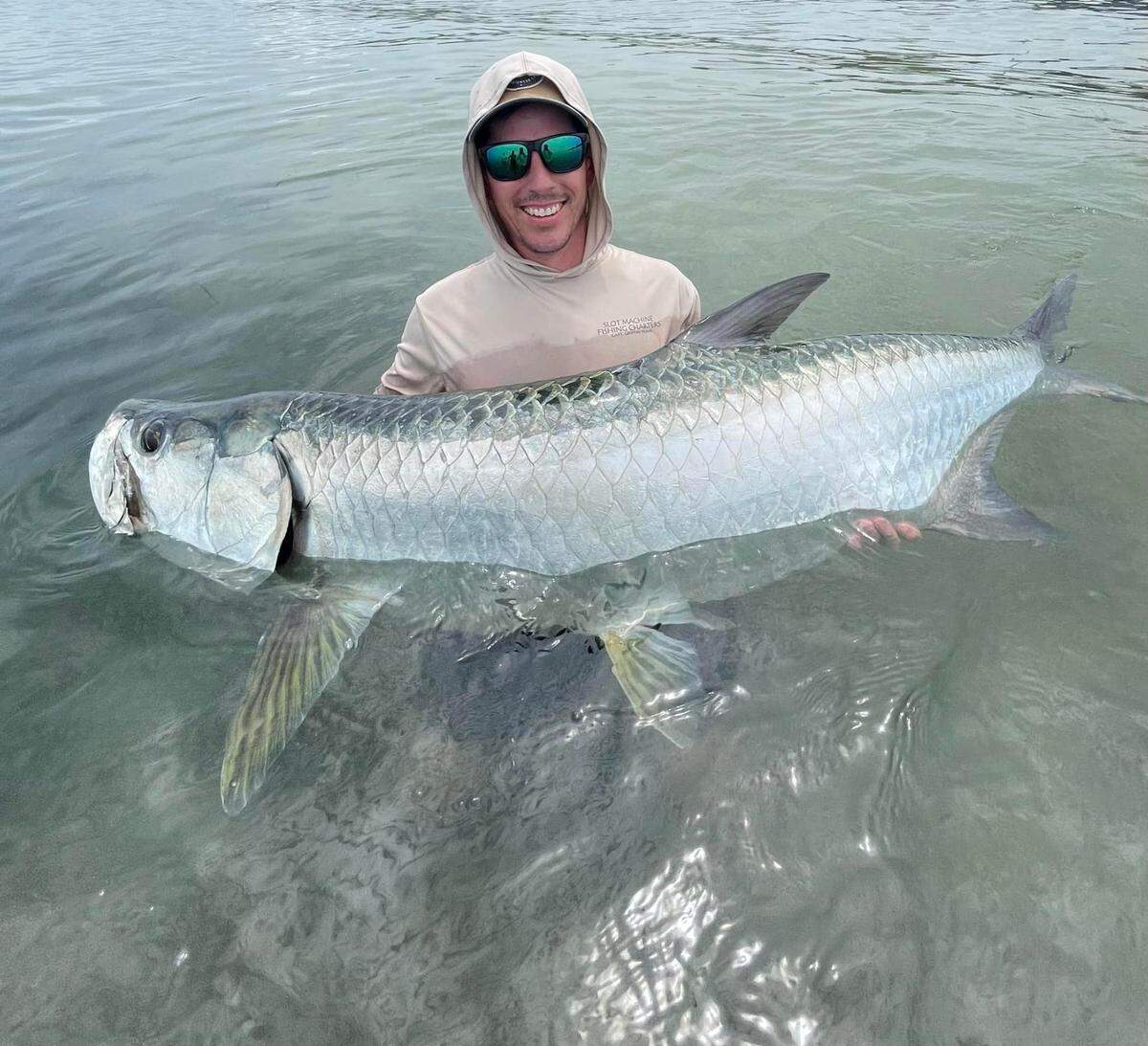 Fisherman catches large tarpon fish near Skyway in Tampa Bay